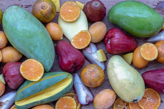 Variety of fresh assorted fruits on the old wooden table. Assorted fruits colorful background, healthy fruits, Selective focus.