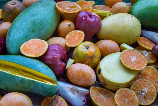 Variety of fresh assorted fruits on the old wooden table. Assorted fruits colorful background, healthy fruits, Selective focus.
