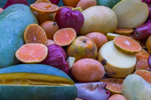 Variety of fresh assorted fruits on the old wooden table. Assorted fruits colorful background, healthy fruits, Selective focus.