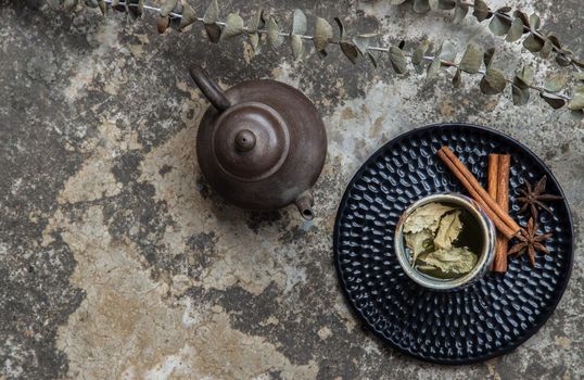 Herbal tea with teapot on Old cement floor. Healthy drinks concept, Copy space, Top view, Selective focus.