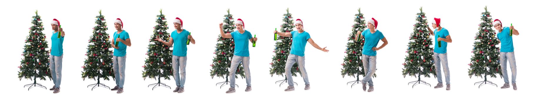 Young man decorating christmas tree isolated on white