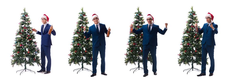 Businessman decorating christmas tree isolated on white