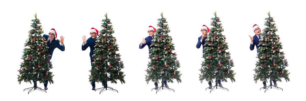 Businessman decorating christmas tree isolated on white