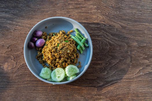 Southern Stir-Fried Pork with Yellow Curry Paste Served with Purple eggplant, Cucumber and Yard long bean. Top view, Copy space, Selective focus.