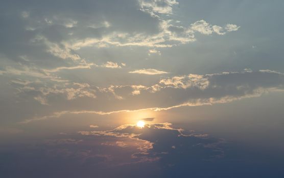 Beautiful sunset sky above clouds with dramatic light. Beautiful blazing sunset landscape, Horizon. Warm Colours, copy space, No focus, specifically.