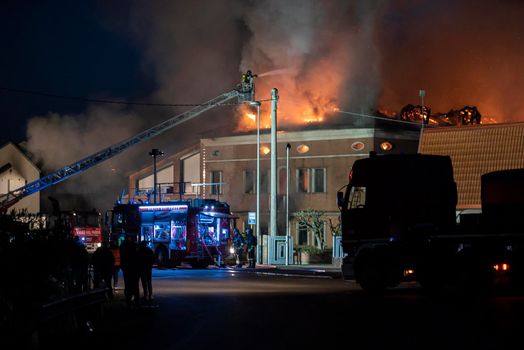 VILLANOVA DEL GHEBBO, ITALY 23 MARCH 2021: House burning at night with firefighters