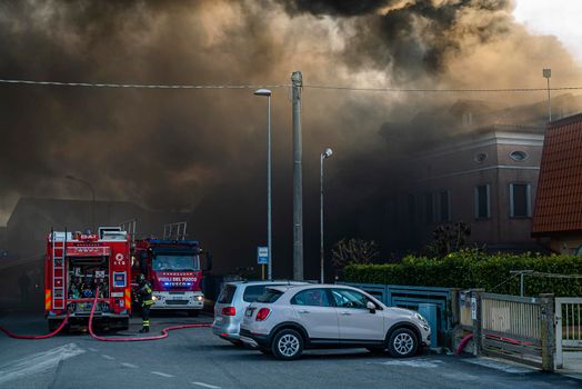 VILLANOVA DEL GHEBBO, ITALY 23 MARCH 2021: Fire house firefighters and smoke