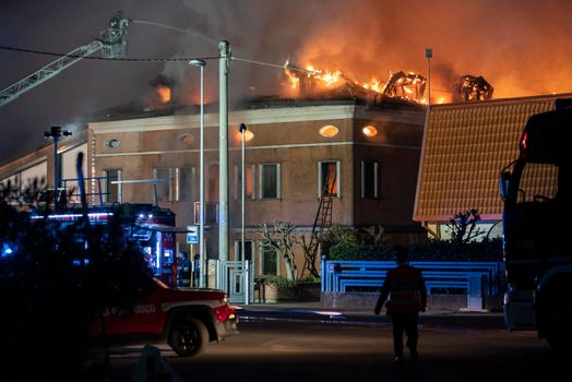 VILLANOVA DEL GHEBBO, ITALY 23 MARCH 2021: House burning at night with firefighters