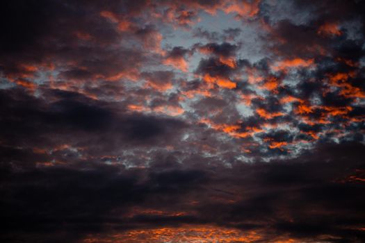 Red Sunlight in the Dark and Dramatic Storm Clouds