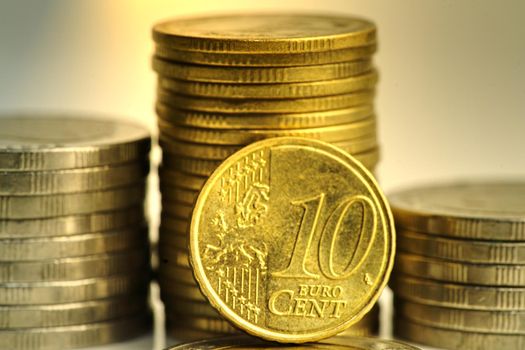 A close-up of 10 cent coins and other coins stacked up. Show the concept of flourishing investment and financial valuation.