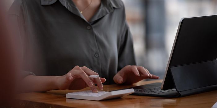 Close up view of bookkeeper or financial inspector hands making report, calculating or checking balance. Home finances, investment, economy, saving money or insurance concept