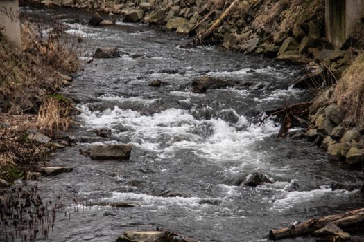 wild river in spring with spray