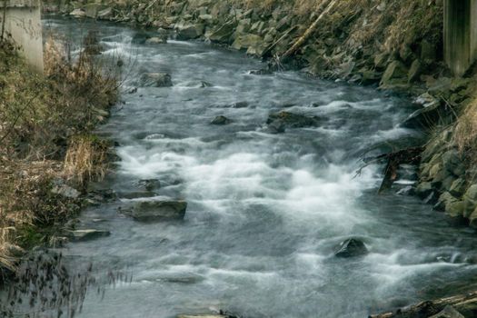 wild river in spring with spray