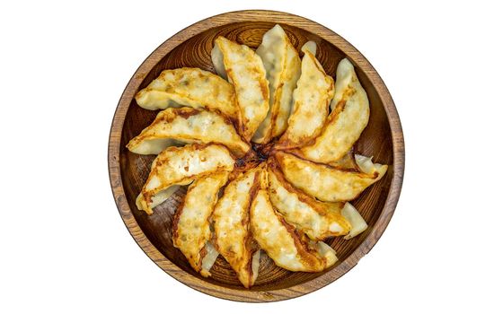 Asian dinner : Fried japanese gyoza dumplings on wooden bowl isolated on white background with clipping path. Top view, Selective focus.