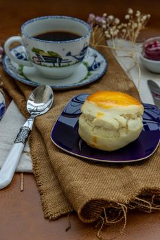 Scones served with black coffee with milk on sack cloth for new morning. Selective focuse.