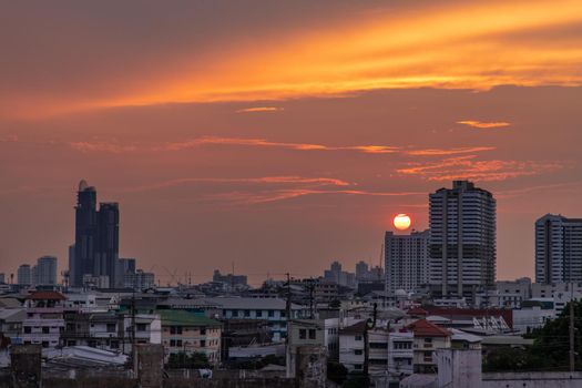 Bangkok, Thailand - 11 Apr, 2020 : Skyscrapers Bangkok City in the light of the setting sun silhouetted cities at sunset. Beautiful sunset over office building center. Selective focus.