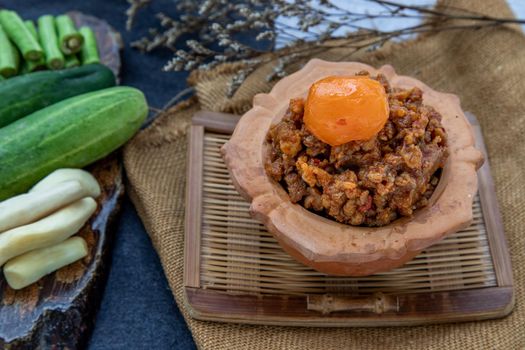 Thai style food : Stir-Fried Pork Crackle with Curry Paste (Fried ginger pork with salted duck egg) Served with vegetable. Delicious and famous Thailand food.
