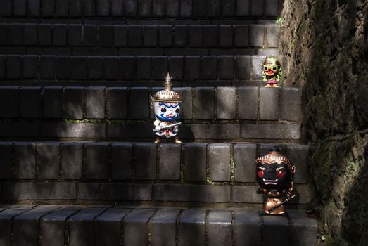 Ravana, Giantess and Hanuman. Standing on a stone stairway with light shining down. Traveller doll.