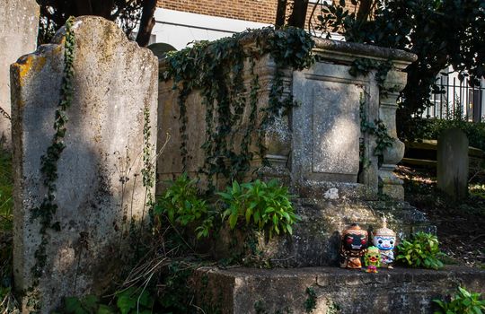 London, England - Jan 24, 2019 : Ravana, Giantess and Hanuman Standing on the grave sign In the cemetery. Traveller doll. No focus, specifically.
