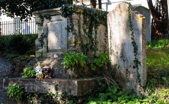 London, England - Jan 24, 2019 : Ravana, Giantess and Hanuman Standing on the grave sign In the cemetery. Traveller doll. No focus, specifically.