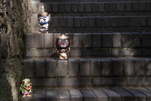Ravana, Giantess and Hanuman. Standing on a stone stairway with light shining down. Traveller doll.