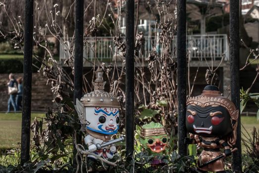 Ravana, Giantess and Hanuman Standing on the wall of the iron fence in the park. Traveller doll.