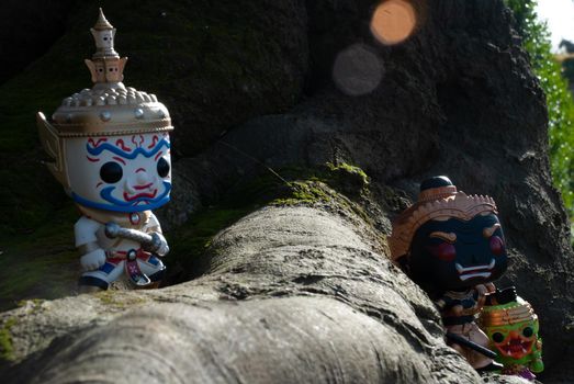 Ravana, Giantess and Hanuman. Standing on the base of a large tree at the park. Traveller doll.
