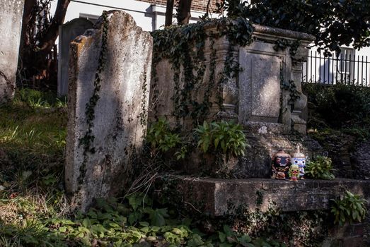 Ravana, Giantess and Hanuman Standing on the grave sign In the cemetery. Traveller doll.