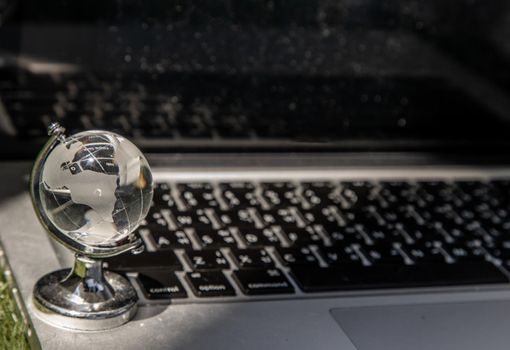 Hourglass on laptop keyboard. Time management concept and Countdown to deadline, Selective focus.