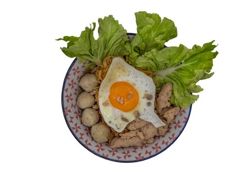 Boil egg noodles with pork ball, minced pork, fried egg and vegetables isolated on white background with clipping path. Selective focus.