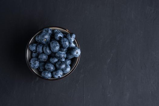 Blueberry antioxidant organic superfood in a bowl concept for healthy eating and dieting nutrition Top view.