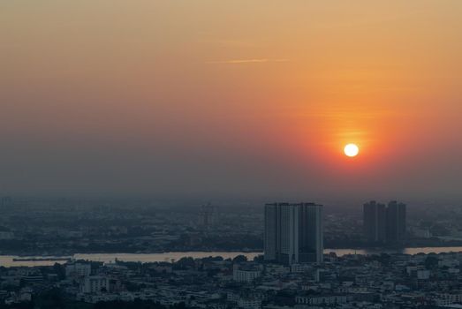 Bangkok, Thailand - Jan 12, 2021 : Aerial view of Amazing beautiful scenery view of Bangkok City skyline and skyscraper before sun setting creates relaxing feeling for the rest of the day. Evening time, Selective focus.