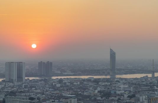 Bangkok, Thailand - Jan 12, 2021 : Aerial view of Amazing beautiful scenery view of Bangkok City skyline and skyscraper before sun setting creates relaxing feeling for the rest of the day. Evening time, Selective focus.