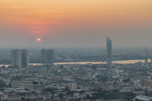 Bangkok, Thailand - Jan 12, 2021 : Aerial view of Amazing beautiful scenery view of Bangkok City skyline and skyscraper before sun setting creates relaxing feeling for the rest of the day. Evening time, Selective focus.