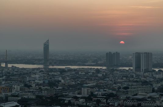 Bangkok, Thailand - Jan 12, 2021 : Aerial view of Amazing beautiful scenery view of Bangkok City skyline and skyscraper before sun setting creates relaxing feeling for the rest of the day. Evening time, Selective focus.