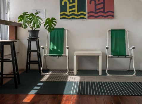 Bangkok, Thailand - 19 Dec, 2019 : Leisure area or living area on a balcony in home or apartment with wooden table and chairs. Selective focus.