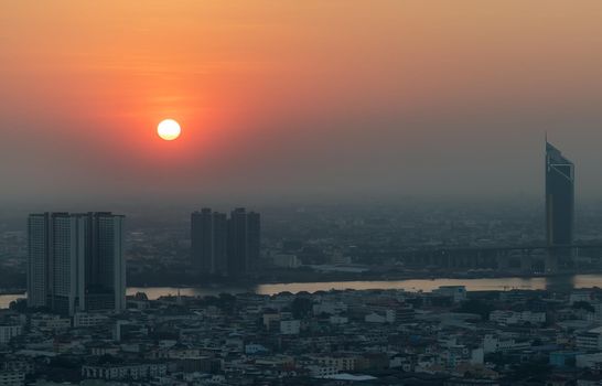 Bangkok, Thailand - Jan 12, 2021 : Aerial view of Amazing beautiful scenery view of Bangkok City skyline and skyscraper before sun setting creates relaxing feeling for the rest of the day. Evening time, Selective focus.