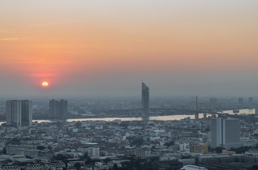 Bangkok, Thailand - Jan 12, 2021 : Aerial view of Amazing beautiful scenery view of Bangkok City skyline and skyscraper before sun setting creates relaxing feeling for the rest of the day. Evening time, Selective focus.