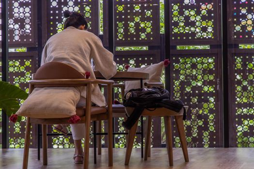 Bangkok, Thailand, Jul 04, 2020 : work from home concept. Social distancing concept. A lady is working in co-working space. Selective focus.