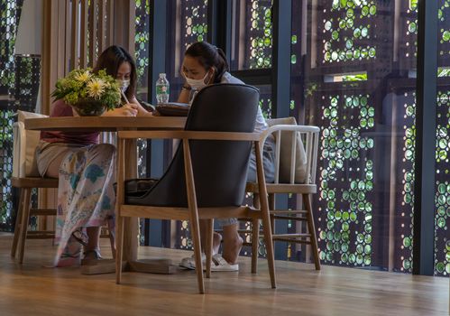 Bangkok, Thailand, Jul 04, 2020 : A meeting of two ladies in co-working space. New normal concept. Selective focus.