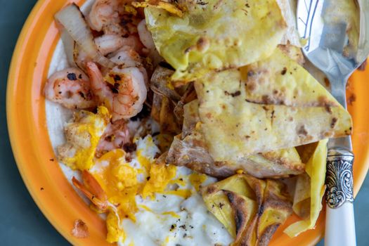 Breakfast with Omelet, Baked Shrimp, Onion and Deep fried Dumplings. Top view, Selective focus.