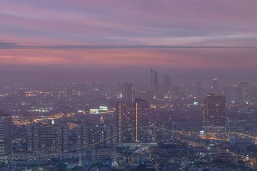 Bangkok, thailand - Dec 23, 2020 : Looking through the window mirror to see The cityscape of Bangkok with skyscrapers and bright glowing lights at night. Focus and blur.