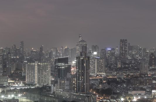 Bangkok, thailand - Dec 23, 2020 : Bangkok downtown cityscape in Business district with bright glowing lights at night give the city a modern style. Dark tone, No focus, specifically.
