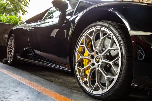 Bangkok, Thailand - 06 Jan 2021 : Close-up of Wheel of Black Lamborghini Sports Car. Lamborghini is Italian sports car. Selective focus.