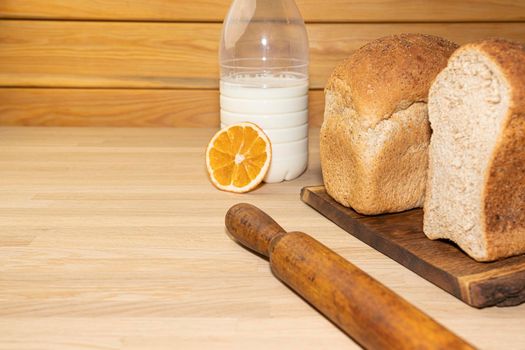 freshly baked bread on a wooden background with milk. High quality photo