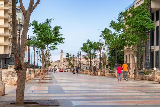 Havana Cuba. November 25, 2020: Paseo del Prado in Havana with trees and benches on its sides, in the background is the Morro lighthouse, places very popular with Cubans and tourists