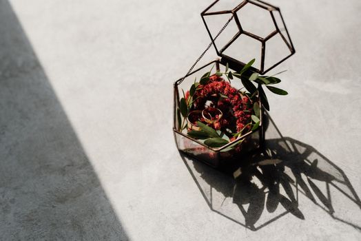 wedding rings in glass box with a red wedding decor