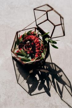 wedding rings in glass box with a red wedding decor