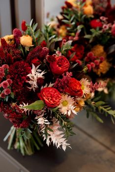 red elegant wedding bouquet of fresh natural flowers and greenery