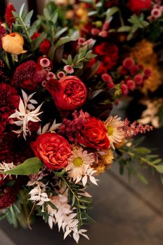 red elegant wedding bouquet of fresh natural flowers and greenery